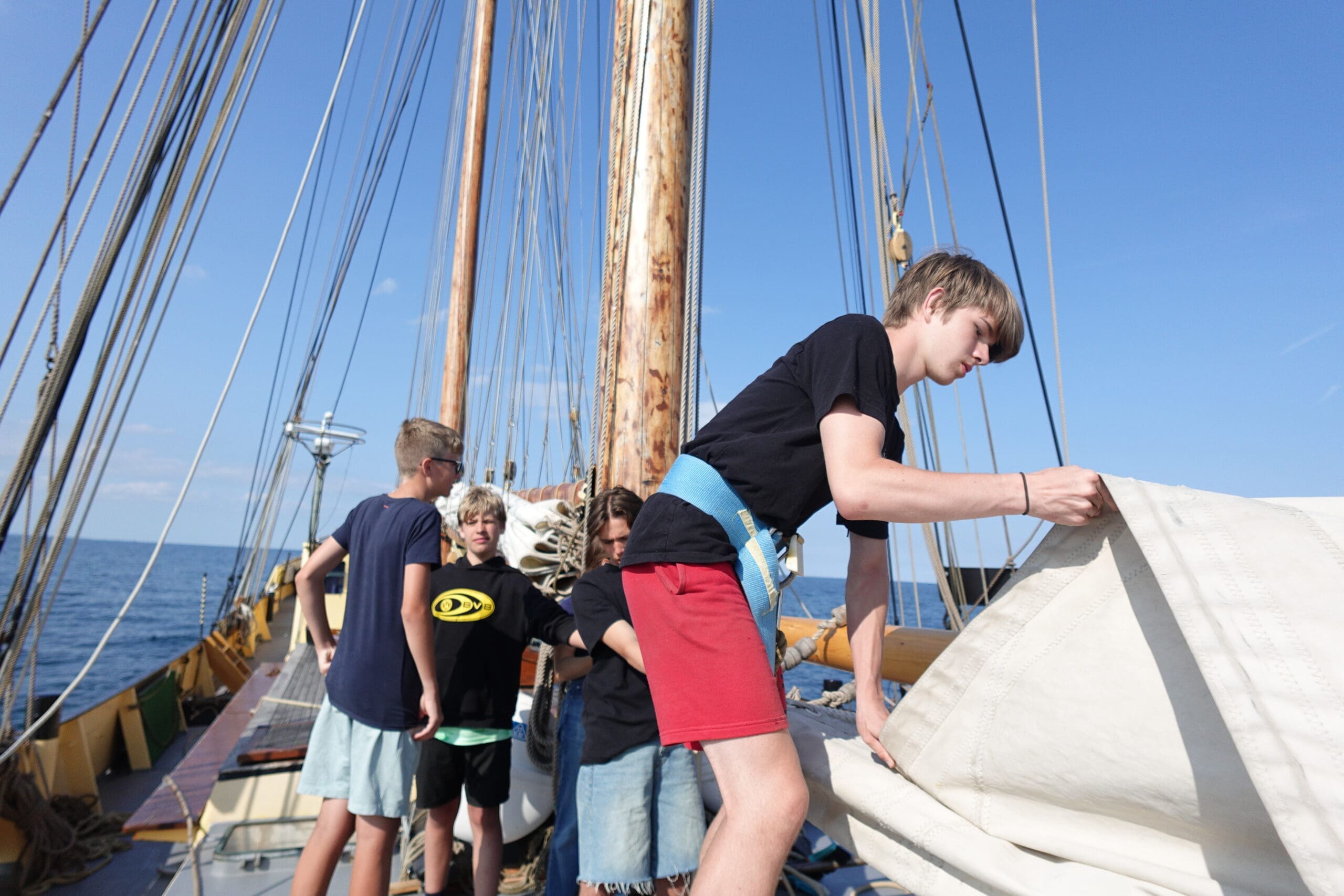 favourite sailing Laurent folding mainsail Teens putting away the sails after a glorious day of sailing together with friends